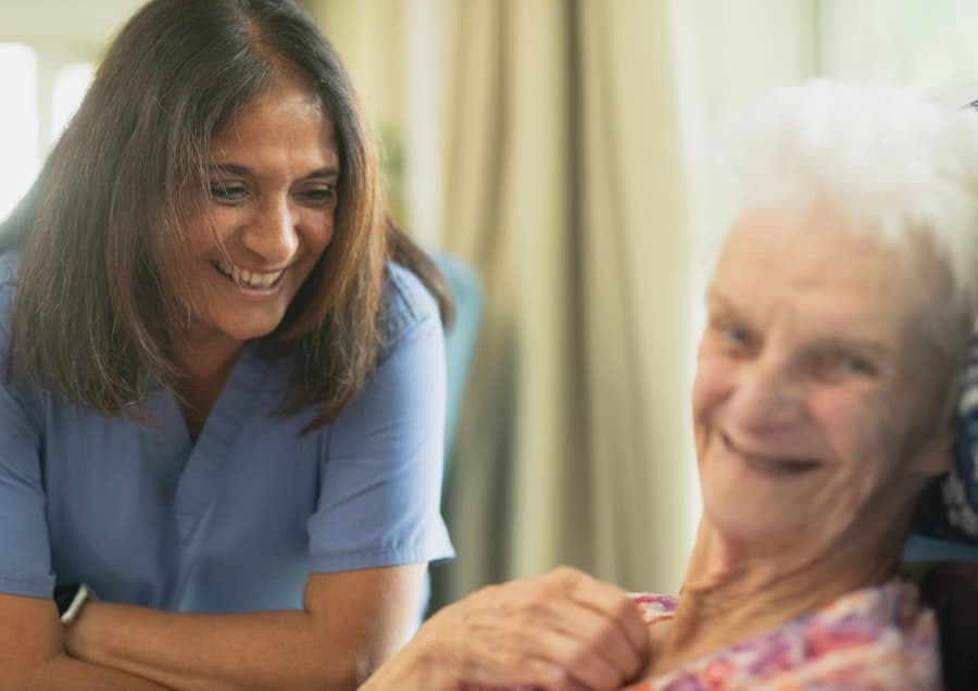 Nurse smiling with an elderly patient
